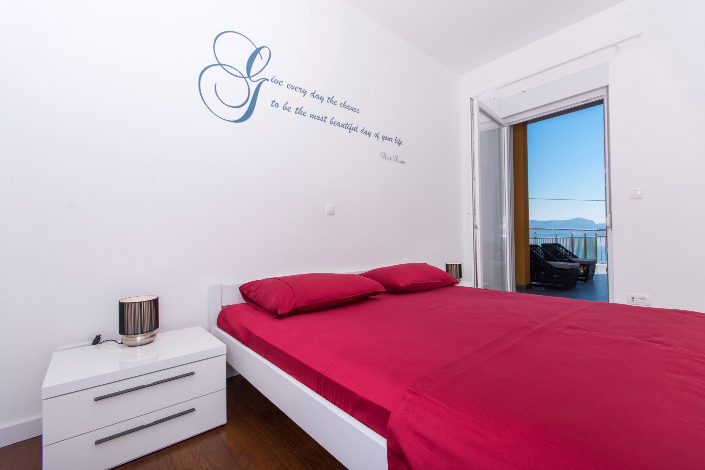 Apartment Sage master bedroom with serif quote on the wall