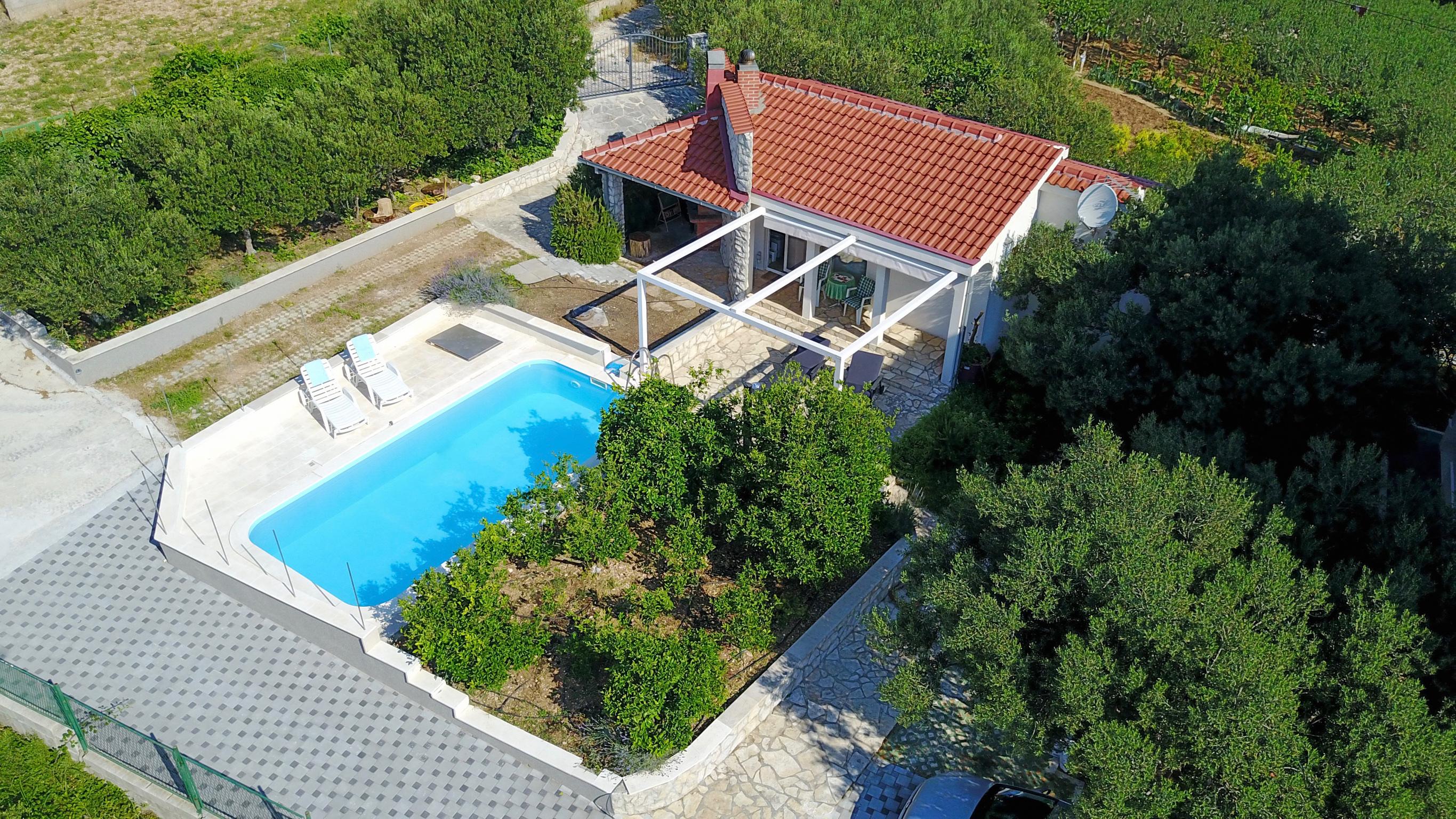 Aerial view of the Adriatic coast at Čiovo — turquoise sea meeting ancient stone terraces