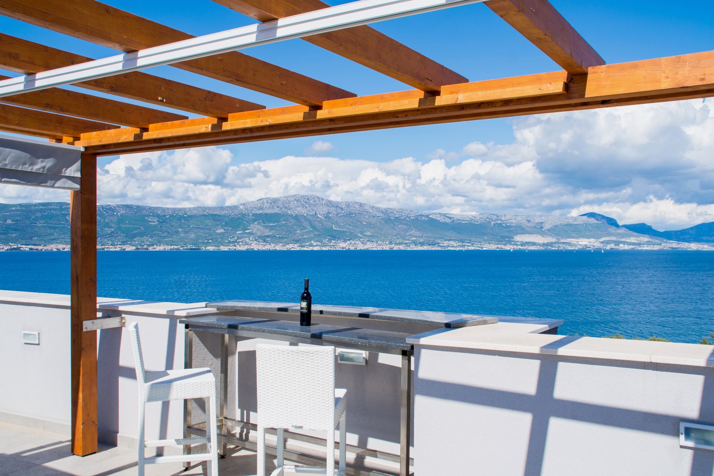 Apartment Lavender rooftop terrace — panoramic view of the Adriatic toward Split and the Dalmatian mountains